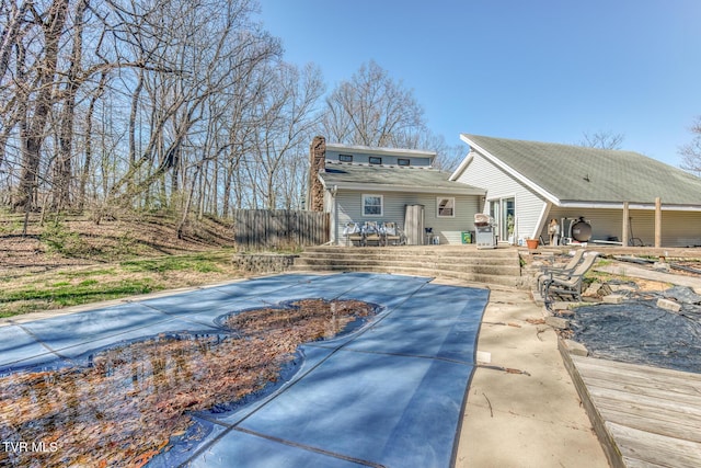 back of property featuring a patio area and fence