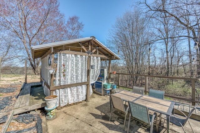 view of patio featuring outdoor dining space and an outdoor structure