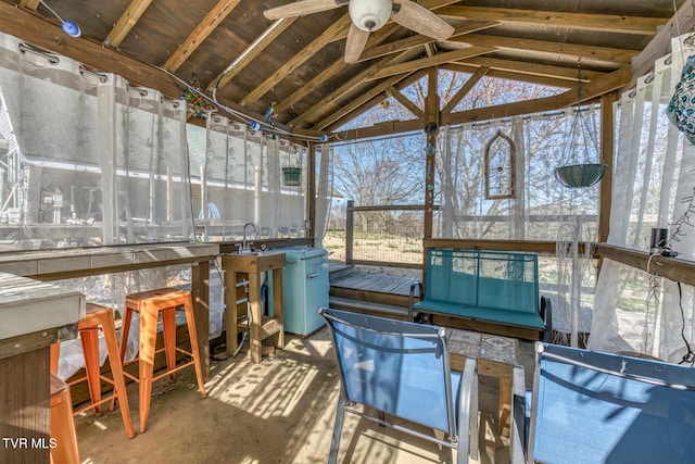 sunroom / solarium featuring a ceiling fan