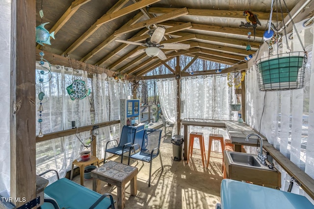 unfurnished sunroom featuring a sink and a ceiling fan