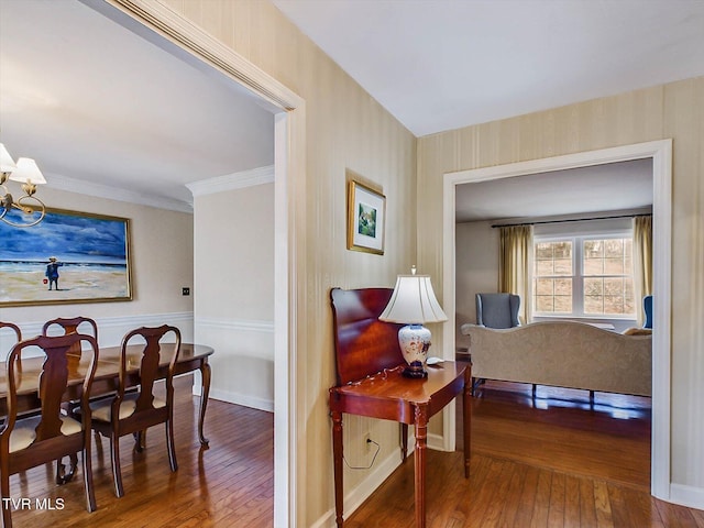 interior space featuring a chandelier, ornamental molding, and hardwood / wood-style flooring