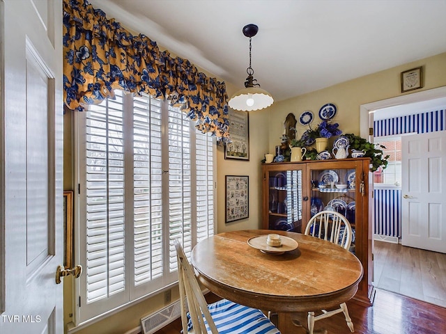 dining area with plenty of natural light and dark wood-type flooring