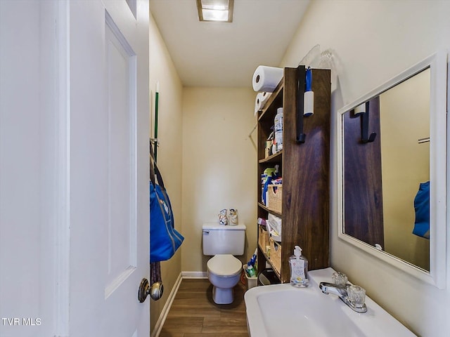 bathroom with sink, wood-type flooring, and toilet