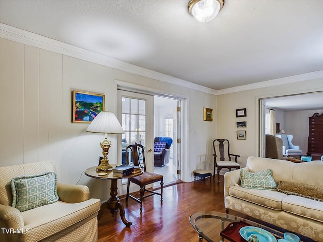 living room featuring dark hardwood / wood-style floors and ornamental molding