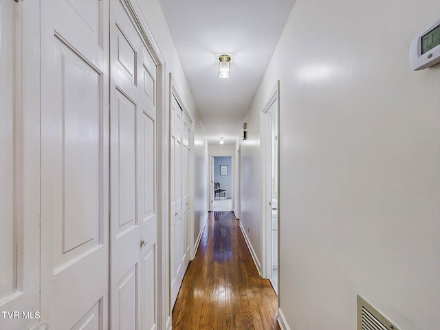 corridor featuring dark hardwood / wood-style flooring