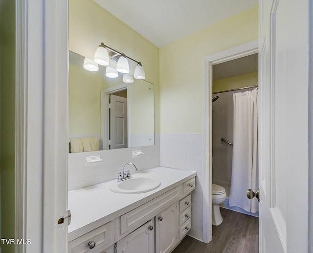 bathroom featuring vanity, wood-type flooring, tile walls, and toilet