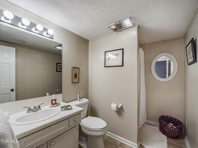 bathroom featuring a textured ceiling, vanity, toilet, and crown molding