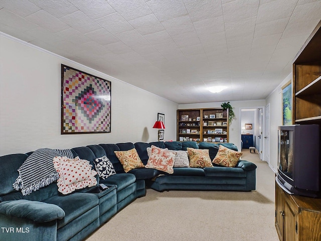 carpeted living room featuring ornamental molding