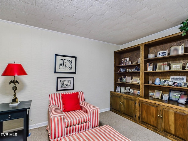 living area featuring crown molding and light colored carpet