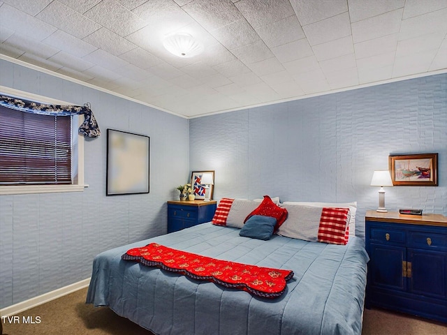 bedroom featuring crown molding and dark carpet