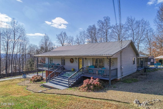 ranch-style home featuring covered porch and a front lawn