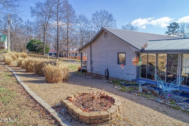 view of home's exterior with a sunroom