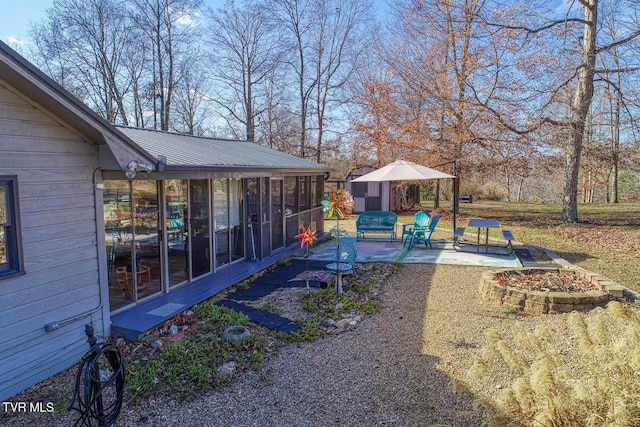 view of yard with a sunroom and a patio