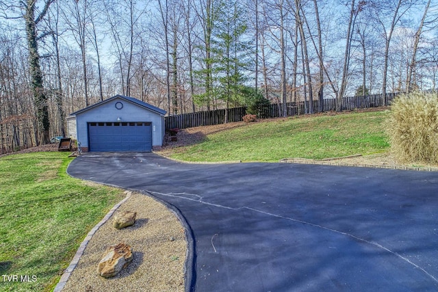 view of yard featuring a garage and an outbuilding