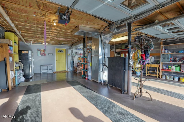 garage featuring heating unit, stainless steel fridge, and a garage door opener