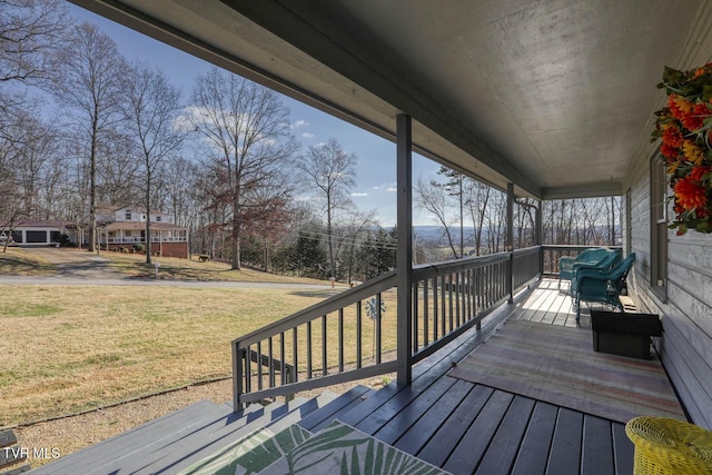 wooden terrace with a porch and a yard