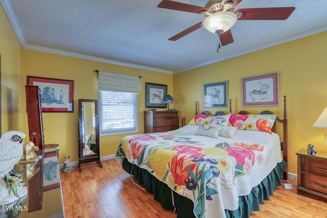 bedroom with a textured ceiling, ceiling fan, light wood-type flooring, and crown molding