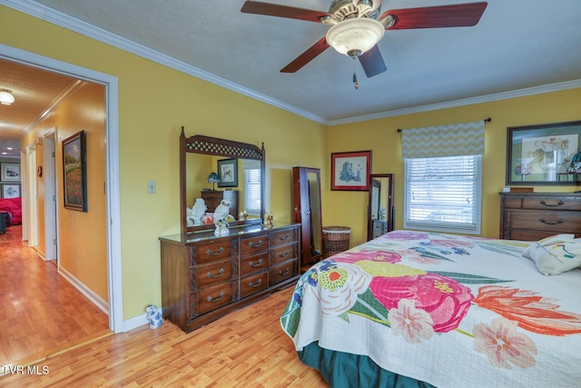 bedroom with ceiling fan, crown molding, and light hardwood / wood-style flooring