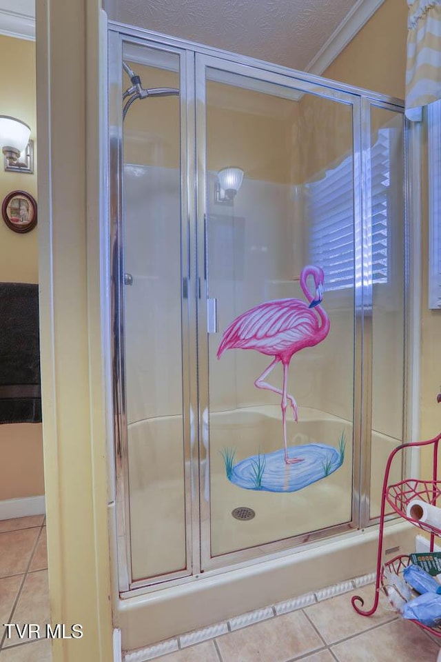 bathroom featuring tile patterned flooring, an enclosed shower, and ornamental molding