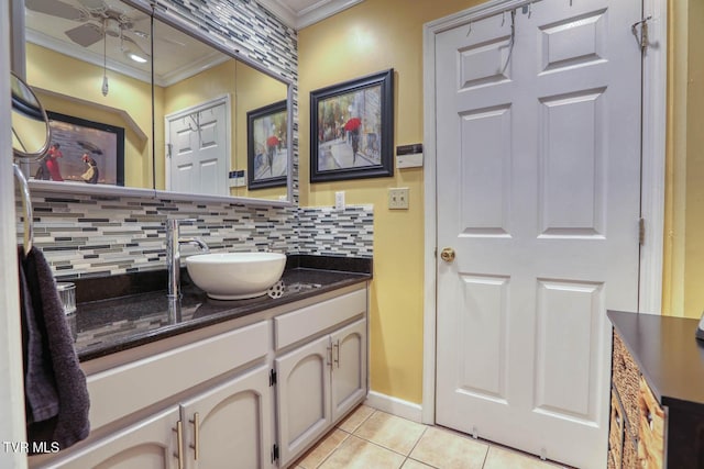 bathroom featuring vanity, backsplash, crown molding, tile patterned flooring, and ceiling fan