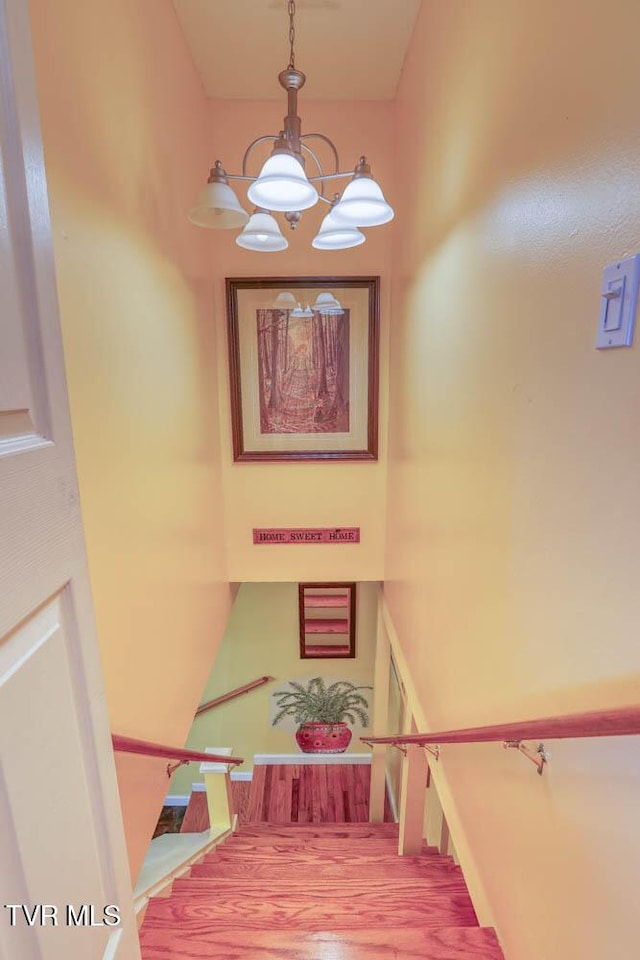 stairs with an inviting chandelier