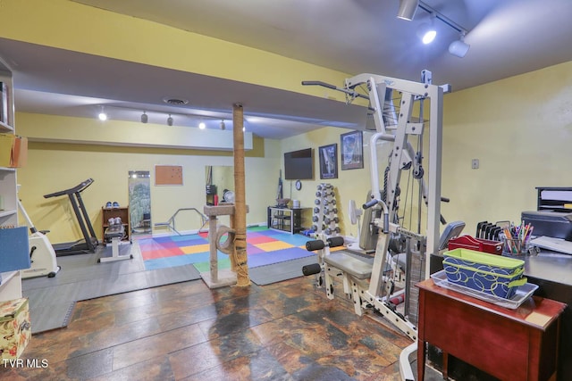 exercise room featuring rail lighting