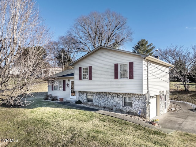 split level home featuring a garage and a front yard