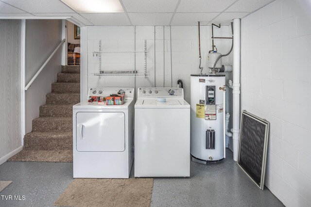 clothes washing area featuring electric water heater and washing machine and clothes dryer