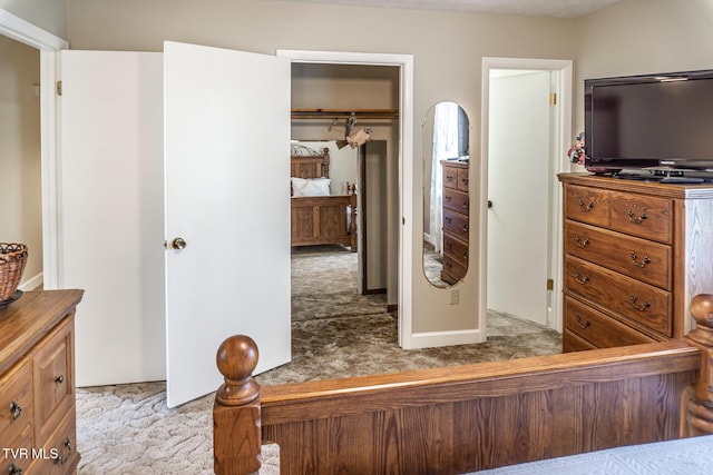 bedroom with light carpet and a closet