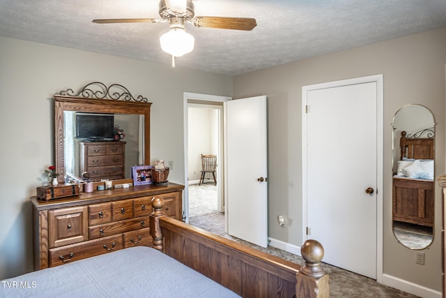 bedroom featuring carpet, ceiling fan, and a textured ceiling