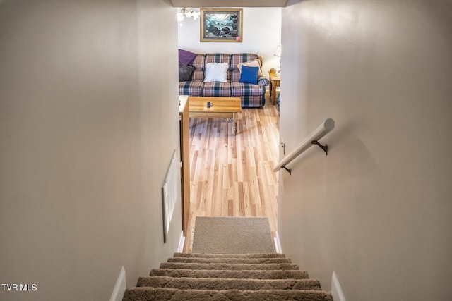 stairs featuring hardwood / wood-style flooring