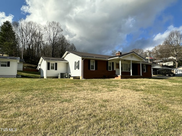 view of front of home featuring covered porch and a front yard