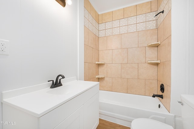 full bathroom with toilet, tiled shower / bath combo, hardwood / wood-style flooring, and vanity