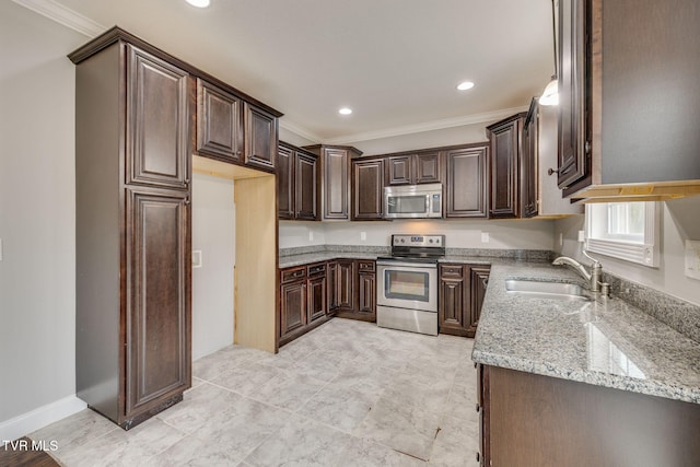 kitchen featuring light stone countertops, appliances with stainless steel finishes, ornamental molding, dark brown cabinets, and sink