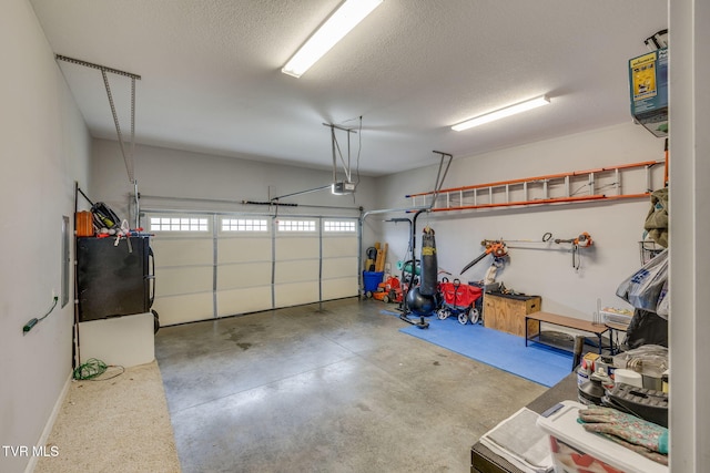 garage with black refrigerator and a garage door opener