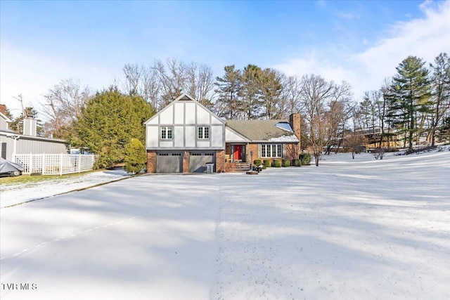 tudor-style house featuring a garage