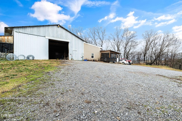 view of outbuilding with a sunroom