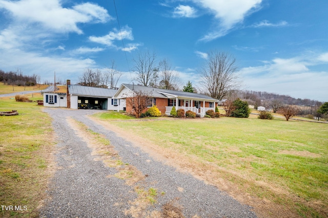 ranch-style home with a porch, a carport, and a front lawn