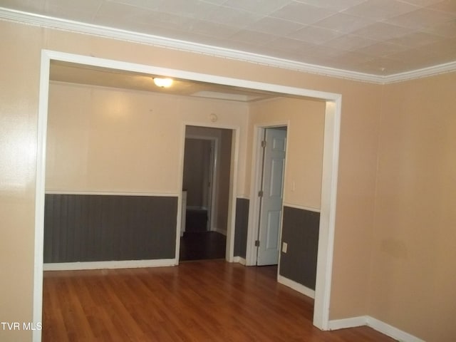 unfurnished room with ornamental molding and hardwood / wood-style flooring