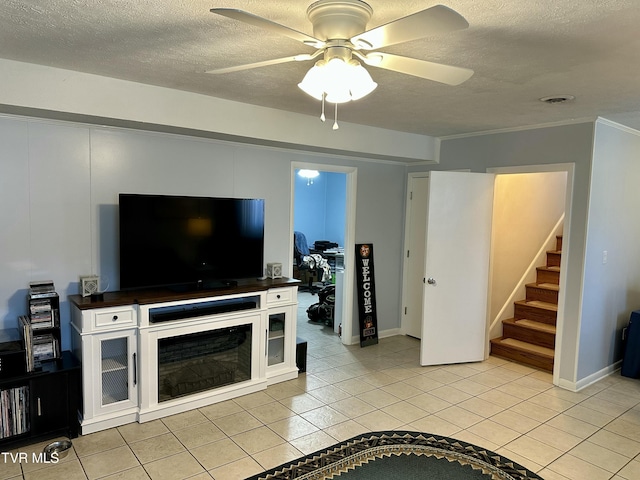 tiled living room with ceiling fan and ornamental molding