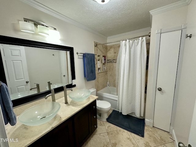 full bathroom with tile patterned floors, crown molding, a textured ceiling, shower / bath combo with shower curtain, and vanity