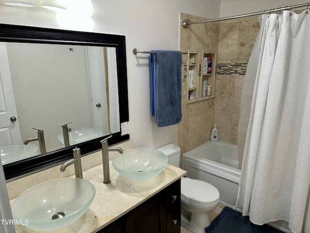 full bathroom featuring shower / bath combo with shower curtain, vanity, and toilet