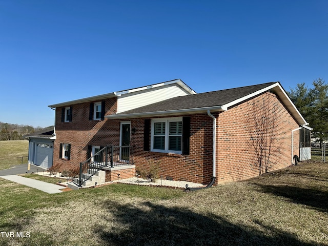 view of front of home with a garage and a front lawn