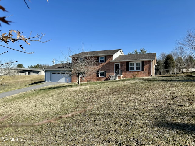 split level home featuring a front yard and a garage