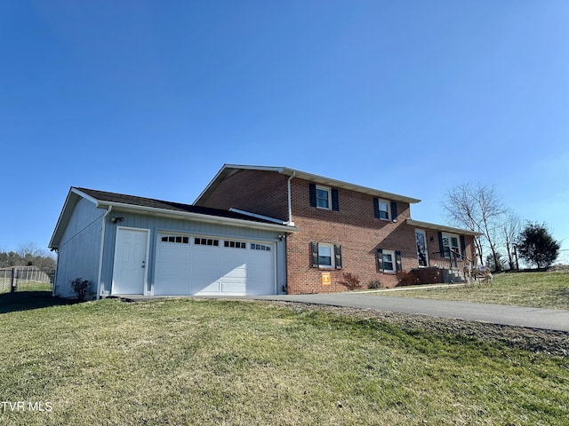 view of front of house with a garage and a front lawn