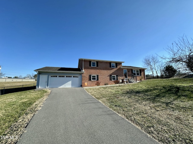 view of front of house with a garage and a front lawn