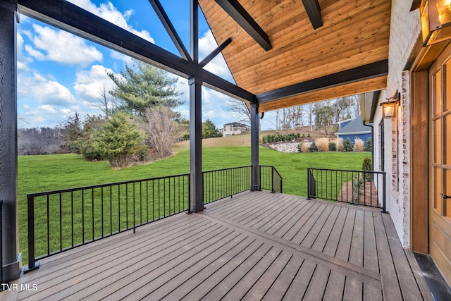 wooden terrace with a lawn