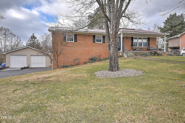 view of front of home with covered porch, a garage, a front lawn, and an outdoor structure