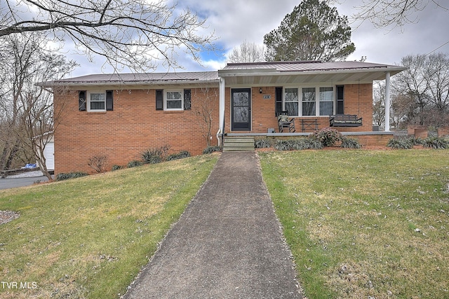 view of front of property with a porch and a front lawn