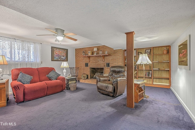 carpeted living room featuring ceiling fan, a textured ceiling, and a brick fireplace